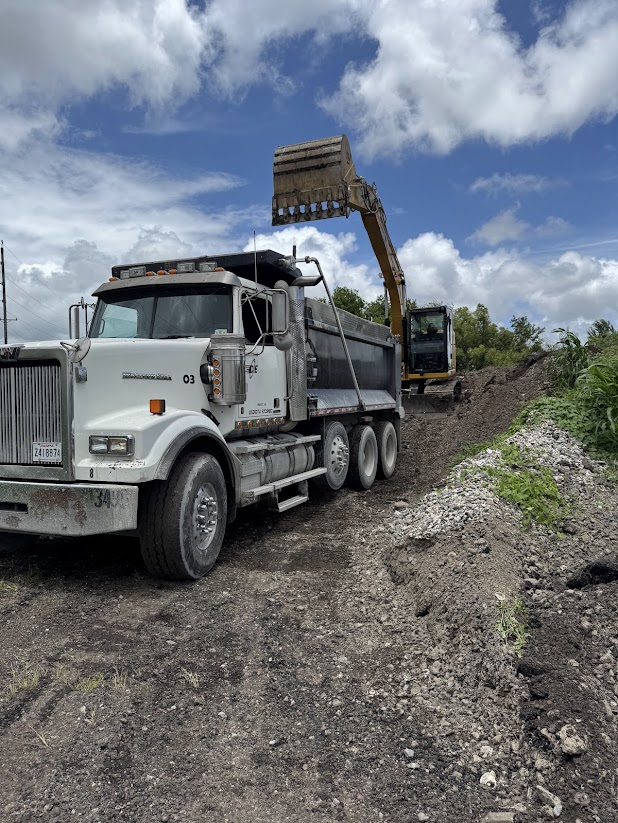 Dison Enterprises dump truck and excavator at a work site