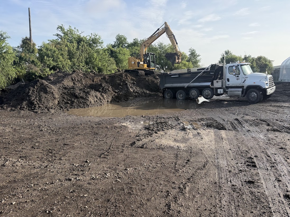 Excavator loading material into a Dison Enterprises dump truck