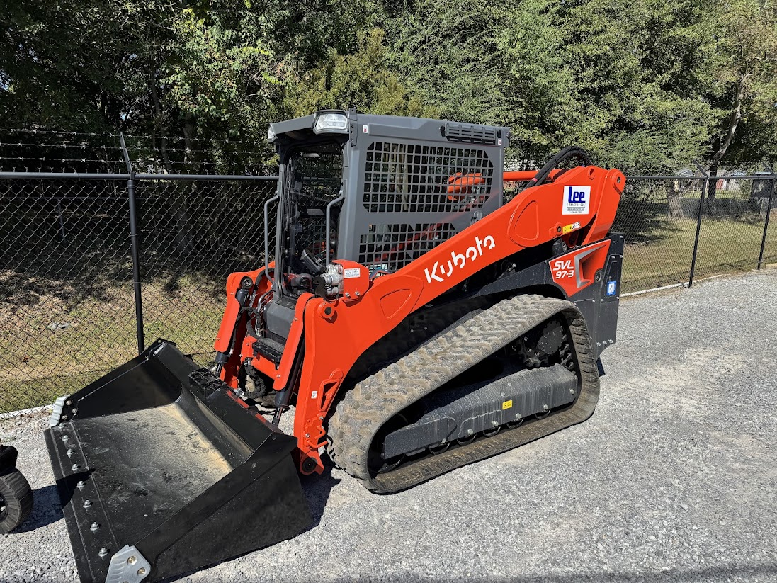 Orange Kubota tracked skid steer with a bucket